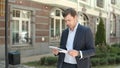 Closeup man reading documents at street. Man going to work in suit at street