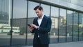 Closeup man receiving good news at street. Business man using phone outdoor Royalty Free Stock Photo