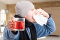 Closeup of man with rhinitis blowing his nose