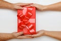 Closeup of a man hand giving a red box with a gift to a woman. Top view. Concept of Valentine Day and Christmas celebration Royalty Free Stock Photo