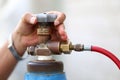 Closeup man`s hand operating valve of gas cylinder Royalty Free Stock Photo