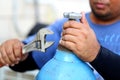 Closeup man`s hand operating valve of gas cylinder Royalty Free Stock Photo