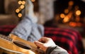 Closeup of man`s hand strumming guitar