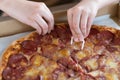 Closeup of a man& x27;s hand taking a slice of pepperoni pizza. Pizza with salami and cheese Royalty Free Stock Photo