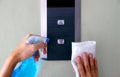 Closeup man`s hands cleaning the elevator panel