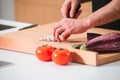 Closeup man's hands cutting vegetables in a kitchen Royalty Free Stock Photo