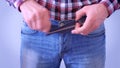 Man hardly buckles the belt of the jeans, pulling the stomach, hands closeup.