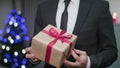Man`s Hands Unwrapping a Christmas Gift