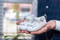 Closeup of a man& x27;s hands holding white baby shoes Royalty Free Stock Photo