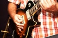 A closeup of a man playing an electric guitar. Royalty Free Stock Photo