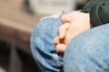 Closeup of a man`s hands, selective focus on intertwined fingers and nails, arms and body are blurred. Action may show Royalty Free Stock Photo