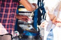 Closeup of man selling Sugarcane Water drink and pouring it in a cup for customer in Kolkata, India