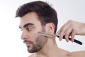 Closeup of man shaving with sharp razor