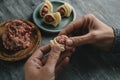 Man filling some Catalan galets with ground meat