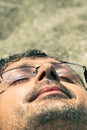 Closeup of man sleeping on the beach Royalty Free Stock Photo