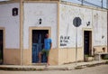 Closeup of a man standing near an old blue door in Valladolid, Yucatan, Mexico