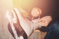 Closeup of man tying shoelace skates on ice rink to woman. Concept caring couple in love