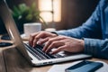 Closeup man typing on laptop keyboard, shallow depth