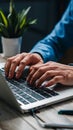 Closeup man typing on laptop keyboard, shallow depth