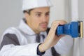 closeup man using sander on wall Royalty Free Stock Photo