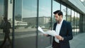 Closeup man walking with papers at street. Businessman reading documents outdoor Royalty Free Stock Photo