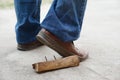 Closeup man wears shoes is stepping on rusty metal nail on wood