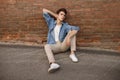 Closeup of man in white T-shirt on brick wall background Royalty Free Stock Photo