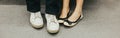 Closeup of man and woman legs in outdoor shoes together. Couple dating sitting together. Love and romance. Romantic dating. Royalty Free Stock Photo