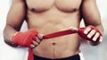 Closeup, man and wrap of hand for fight, martial arts and boxing at fitness and workout studio. Strap, boxer and gym to Royalty Free Stock Photo