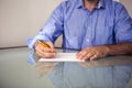 Closeup of man writing on a piece of paper Royalty Free Stock Photo