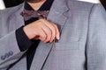 Closeup man's chest area wearing formal suit and tie, placing pen in jacket pocket, men getting dressed concept