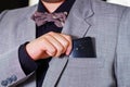 Closeup man's chest area wearing formal suit and tie, placing phone in jacket pocket, men getting dressed concept