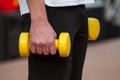 man with yellow dumbbells in hands