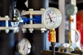 Closeup of manometer, measuring gas pressure. Pipes and valves a Royalty Free Stock Photo