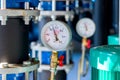 Closeup of manometer, measuring gas pressure. Pipes and valves a Royalty Free Stock Photo