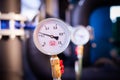 Closeup of manometer, measuring gas pressure. Pipes and valves a Royalty Free Stock Photo