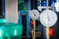 Closeup of manometer, measuring gas pressure. Pipes and valves a Royalty Free Stock Photo