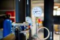 Closeup of manometer, measuring gas pressure. Pipes and valves a Royalty Free Stock Photo
