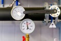 Closeup of manometer, measuring gas pressure. Pipes and valves at industrial plant. Pressure gauge, measuring instrument close up