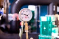 Closeup of manometer, measuring gas pressure. Pipes and valves at industrial plant. Pressure gauge, measuring instrument close up Royalty Free Stock Photo