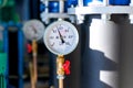 Closeup of manometer, measuring gas pressure. Pipes and valves at industrial plant. Pressure gauge, measuring instrument close up Royalty Free Stock Photo
