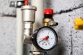 Closeup of manometer, pipes and faucet valves of heating system in a boiler room at home Royalty Free Stock Photo