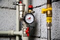 Closeup of manometer, pipes and faucet valves of heating system in a boiler room at home Royalty Free Stock Photo