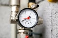 Closeup of manometer, pipes and faucet valves of heating system in a boiler room Royalty Free Stock Photo