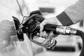 Closeup of mans hand pumping gasoline fuel in car at gas station. Royalty Free Stock Photo
