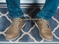 Closeup mans shoelaces tied together, April fools day