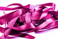 Mauve tangled satin ribbons on white. Royalty Free Stock Photo
