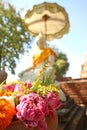 Many of Lotus and Marigold Flowers for Offering in a Vase with Blurry White Buddha Image in Background, Thailand Royalty Free Stock Photo