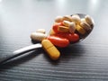 Closeup many pills on stainlees spoon Royalty Free Stock Photo