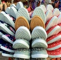 Closeup of many trendy canvas footwear for ladies kept in a tray on the street in a market Royalty Free Stock Photo